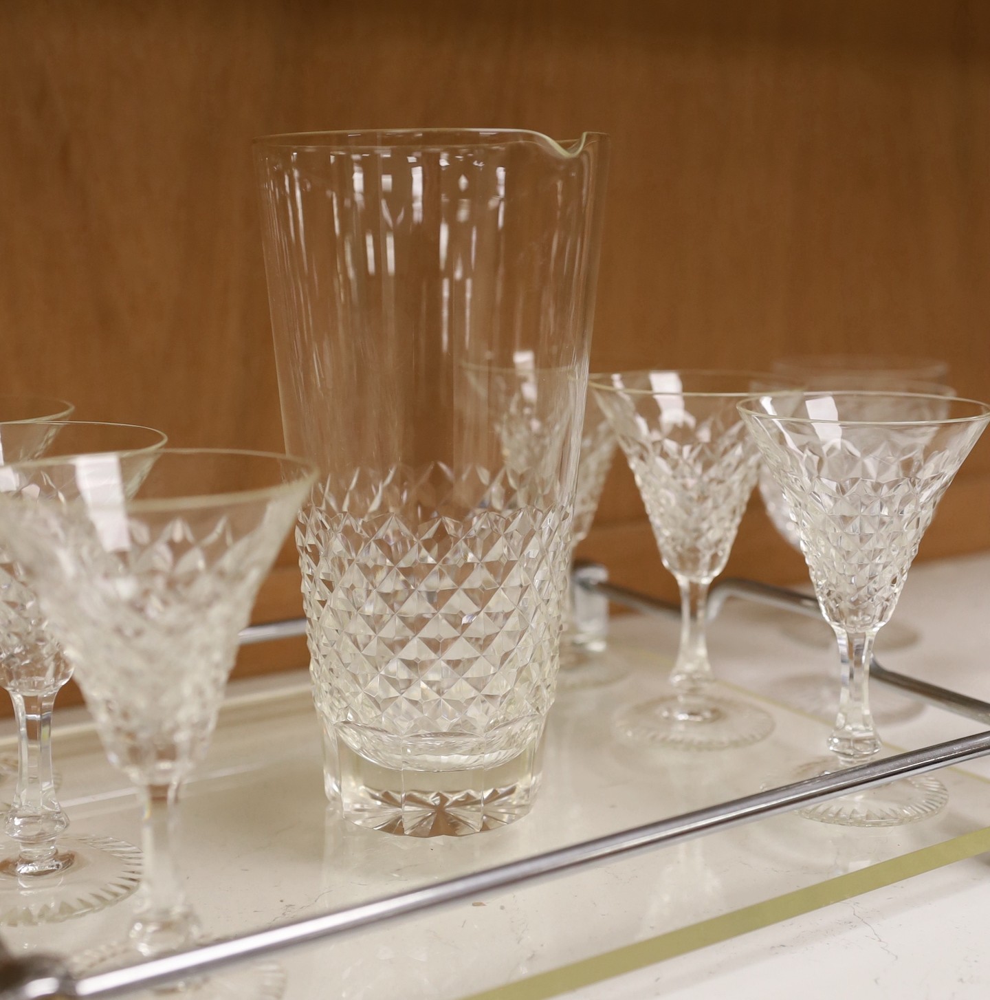 A mid century chrome and perspex drinks tray with 6 cocktail glasses, mixing glass and 8 wine glasses